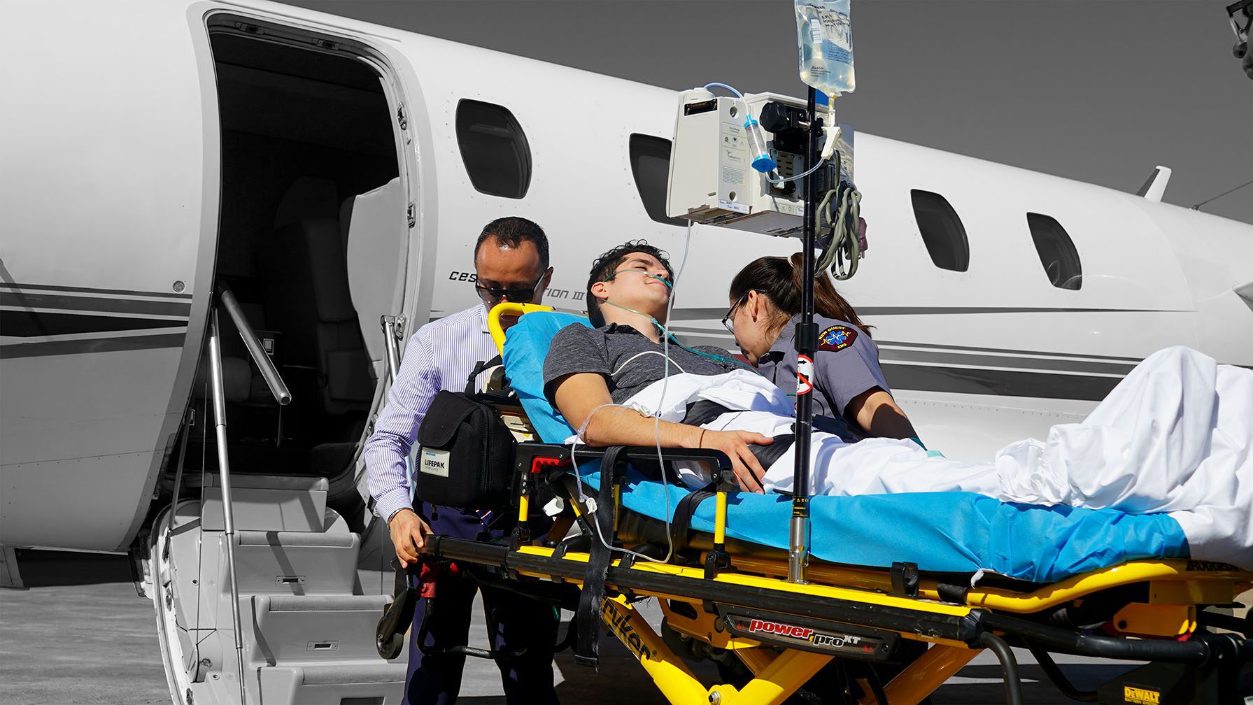 Air Medical Transport -Critical Care Air Ambulance Fixed-wing air ambulance coordination team monitoring a patient transfer