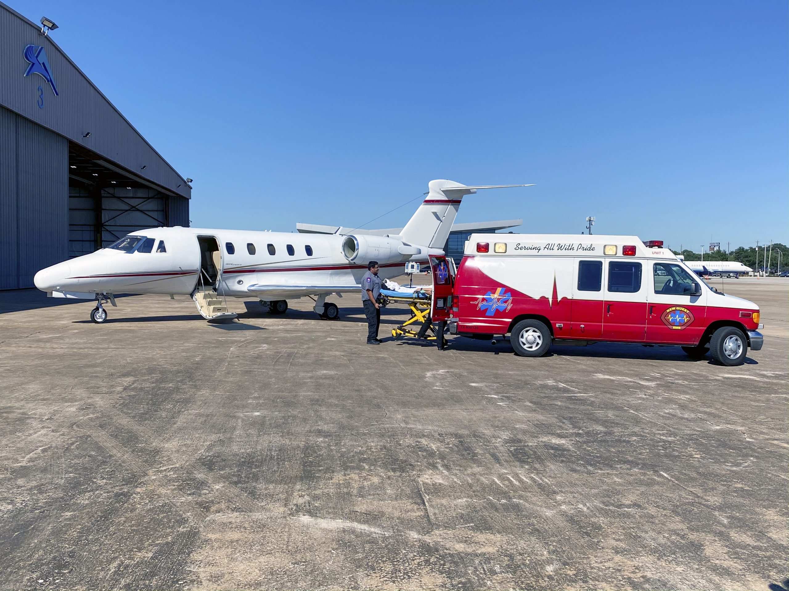 Fixed-wing air ambulance aircraft positioned at an international airport for medical transport