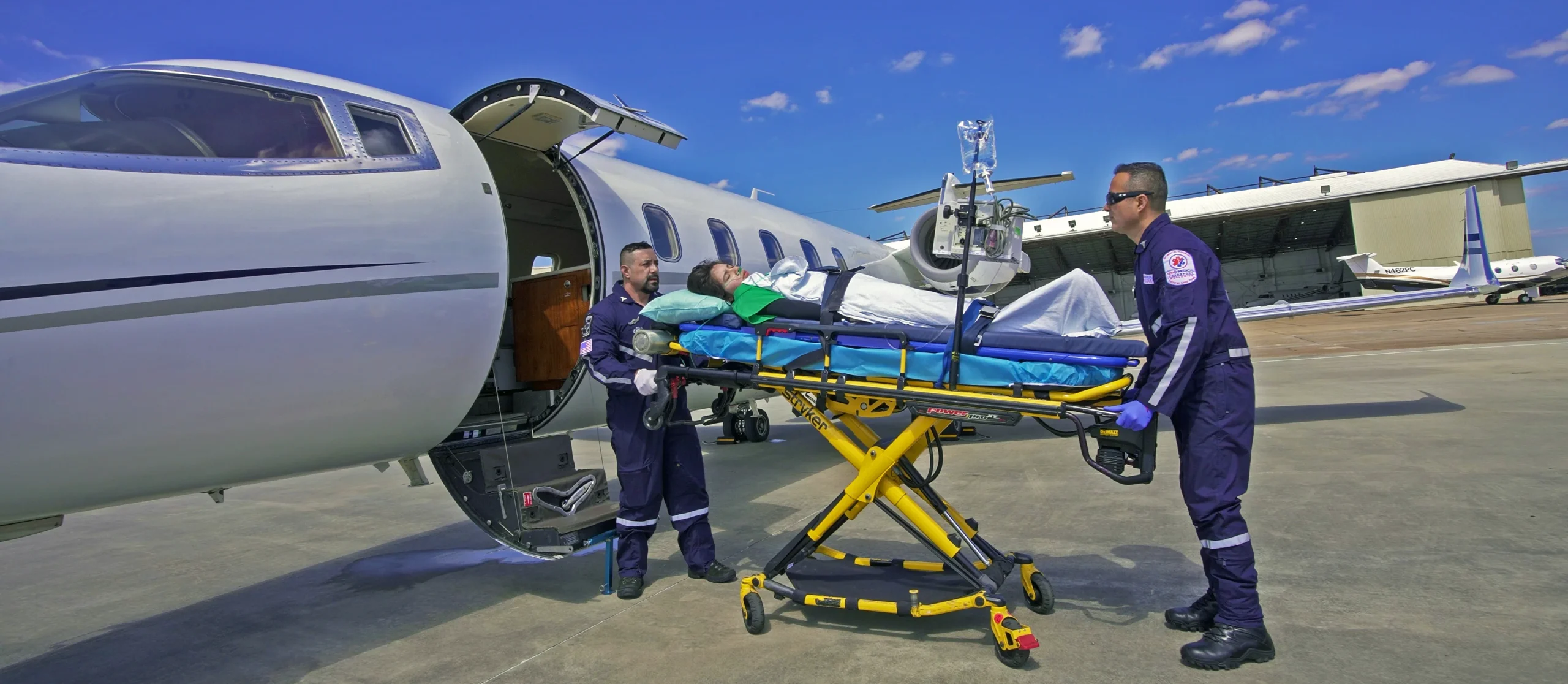 Fixed-wing air ambulance coordination team monitoring a patient transfer